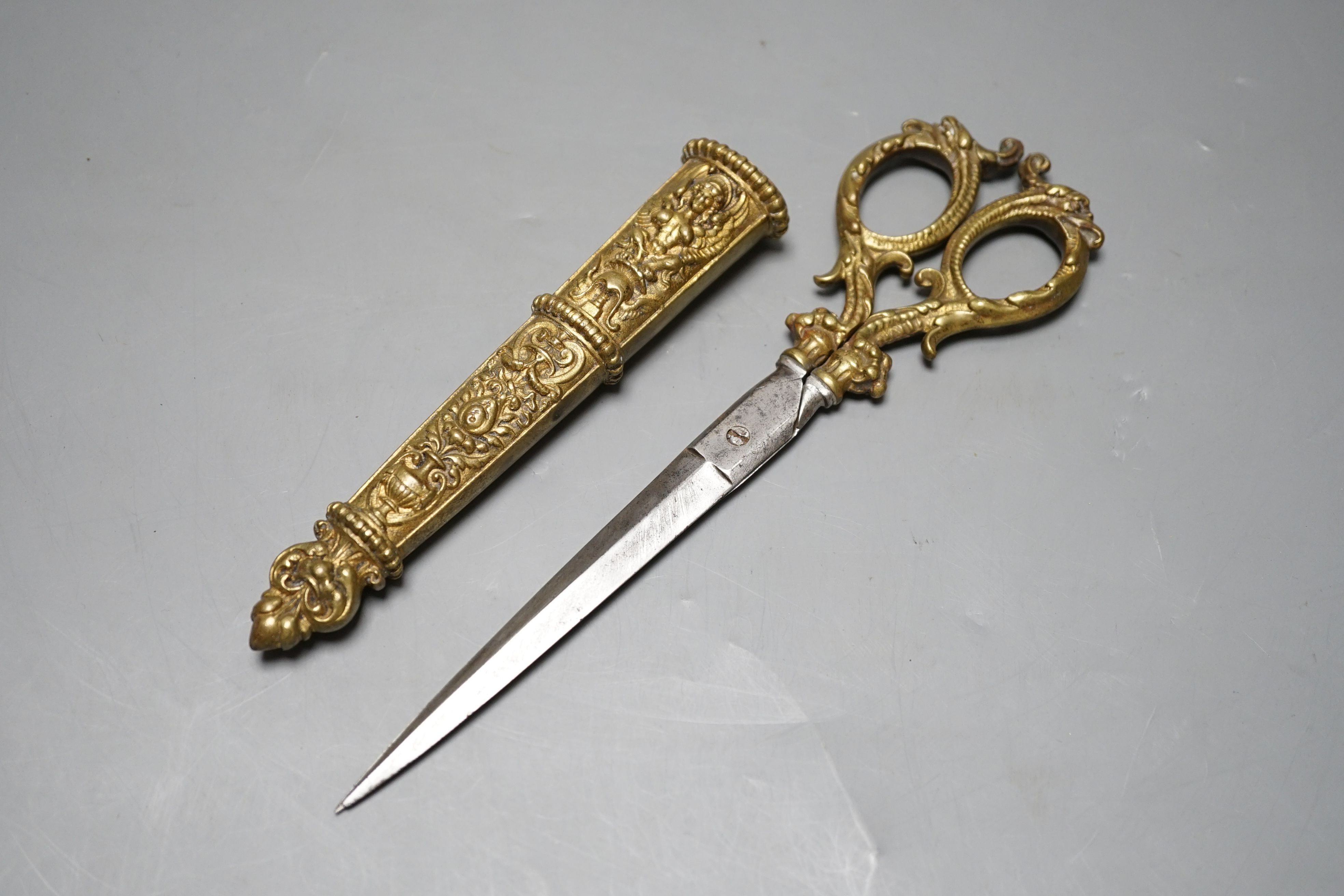 A pair of embossed brass scissors and cover